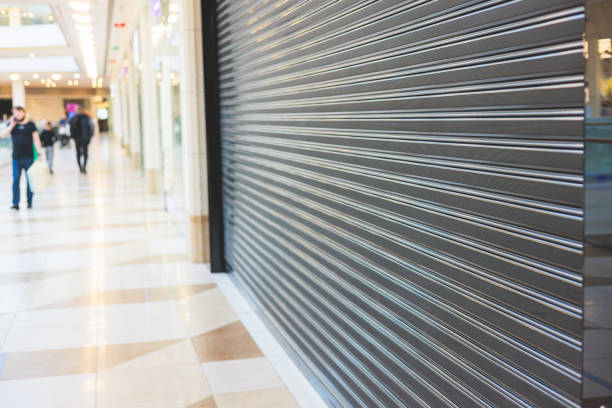 stores show case in shopping mall closed due to sanctions, boycott and embargo, mass market cloth shops work stoppage with closed storefronts, retail business suspension and brands leaving market - department store shopping mall store inside of imagens e fotografias de stock