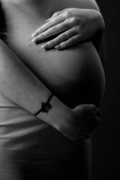 istock Pregnant woman holding her belly. 27 weeks 1390646536