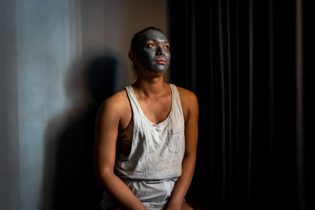 Portrait of Asian drag queen Gisele wearing a rejuvenating clay face mask before getting ready to perform at an LGBTQ bar