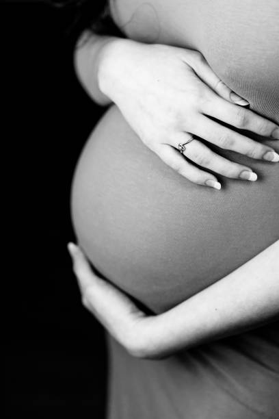 istock Pregnant woman holding her belly. 27 weeks 1390646564