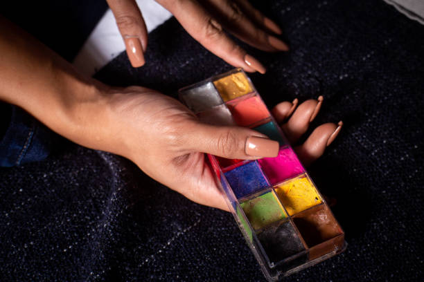 istock Hand with acrylic nails holding face makeup 1390647387
