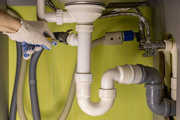 istock hand tightens a bolt while repairing the drain under the sink 1390650089