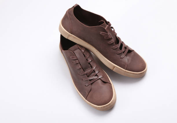 istock Mens brown leather sneakers on a gray background 1390653602