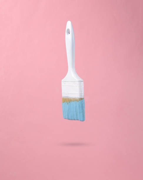 istock Paint brush with dripping turquoise paint on a pink background. Minimal creative layout. Concept art. 1390653714
