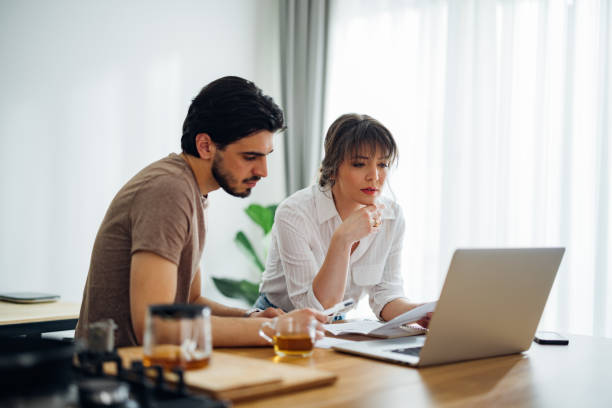 istock Serious Couple Paying Bills at Home 1390654295