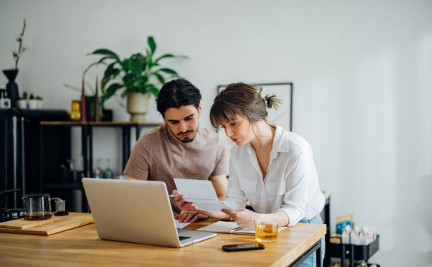 istock Serious Couple Paying Bills at Home 1390654296