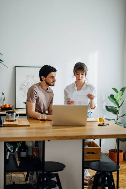 istock Serious Couple Paying Bills at Home 1390654297