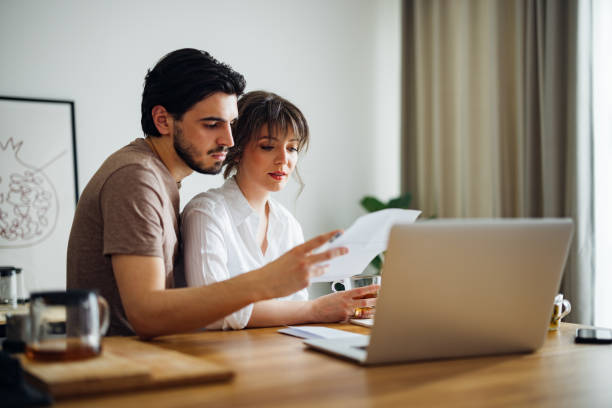 istock Serious Couple Paying Bills at Home 1390654303