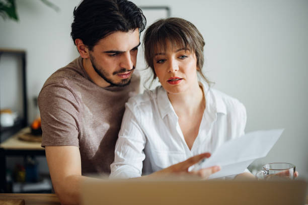 istock Serious Couple Paying Bills at Home 1390654304