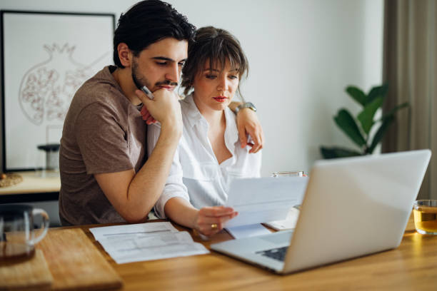 istock Serious Couple Paying Bills at Home 1390654305