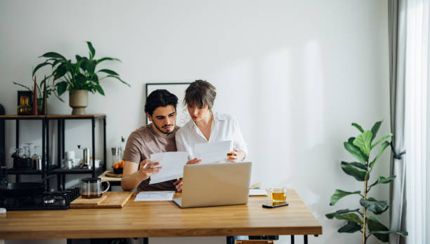 istock Serious Couple Paying Bills at Home 1390654306