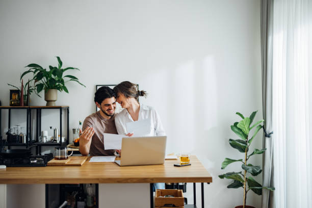 istock Happy Couple Paying Bills at Home 1390654310