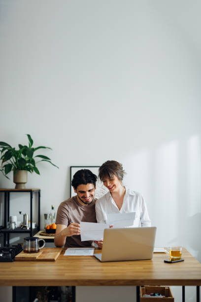 istock Smiling Couple Paying Bills at Home 1390654312