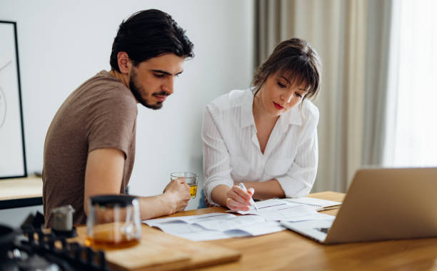 istock Serious Couple Paying Bills at Home 1390654316