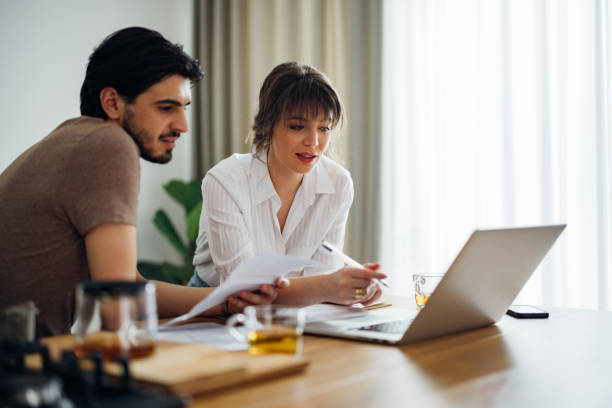 istock Serious Couple Paying Bills at Home 1390654320