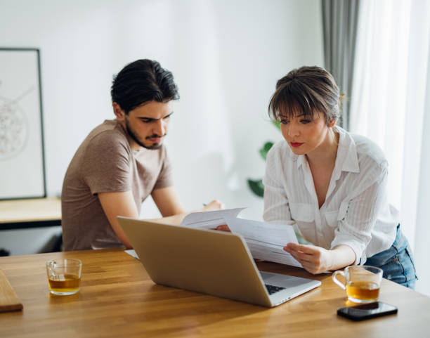 istock Serious Couple Paying Bills at Home 1390654322