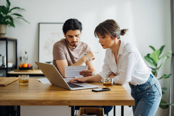 Serious Couple Paying Bills at Home