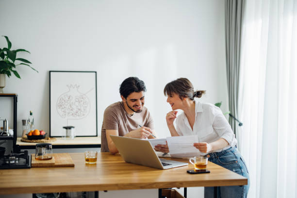 istock Happy Couple Paying Bills at Home 1390654324