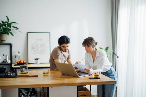 istock Serious Couple Paying Bills at Home 1390654325