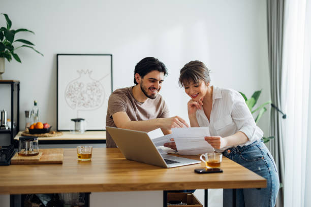 Smiling Couple Paying Bills at Home