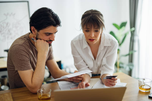 istock Serious Couple Paying Bills at Home 1390654332