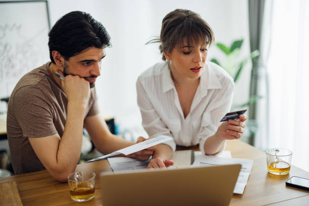 istock Serious Couple Paying Bills at Home 1390654334