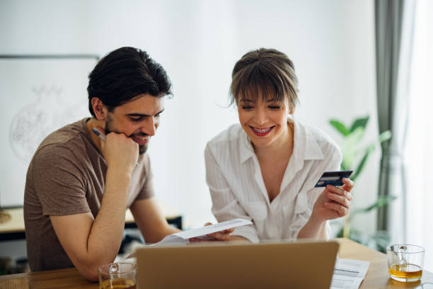 istock Happy Couple Paying Bills at Home 1390654340