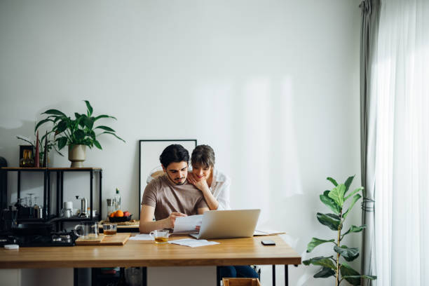 istock Smiling Couple Paying Bills at Home 1390654884