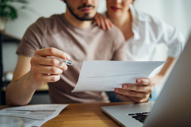 Unrecognizable Couple Paying Bills at Home stock photo