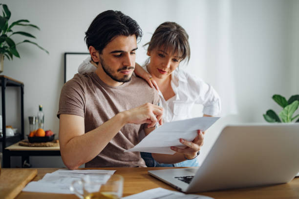 istock Happy Couple Paying Bills at Home 1390654892