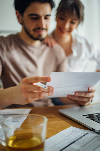 istock Anonymous Couple Paying Bills at Home 1390654895
