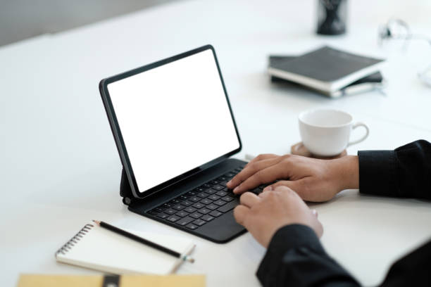 istock Young man working on his laptop with blank copy space screen for your advertising text message in office, Back view of business man hands busy using laptop at office desk 1390655941
