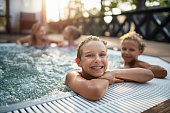 Family enjoying outdoors hot tub hot tub in the back yard