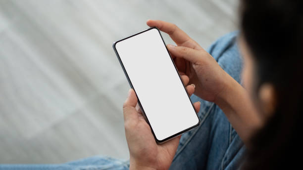 istock Woman holding smart phone with blurred background. For Graphic display montage 1390656583