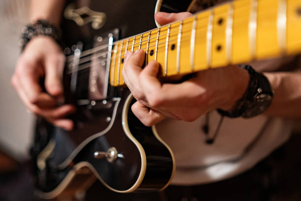 istock Unrecognizable male hands playing electric guitar 1390656592