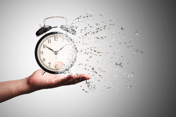 istock Retro black alarm clock dissolving into a little particles for time can not return and never wait anyone , Time management concept. 1390656777