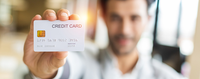 Close up credit card in the hand of businessman,  purchase and payment concept.