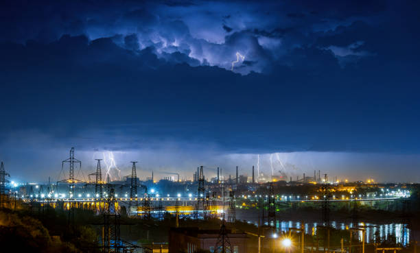Spectacular industrial landscape with night thunderstorm, electric power lines and hydroelectric power plant in Zaporizhzhia, Ukraine Spectacular industrial landscape with night thunderstorm, electric power lines and hydroelectric power plant in Zaporizhzhia, Ukraine lightning tower stock pictures, royalty-free photos & images