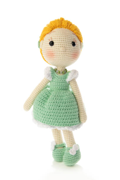 A crochet Amigurumi toy of a of cute stuffed white sheep.