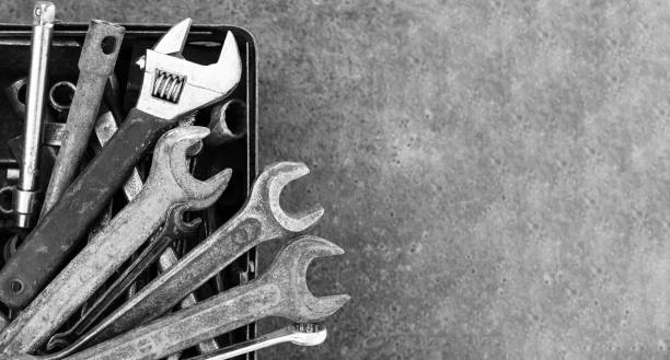 istock Toolbox of old wrench and garage tools on stone background 1390662675