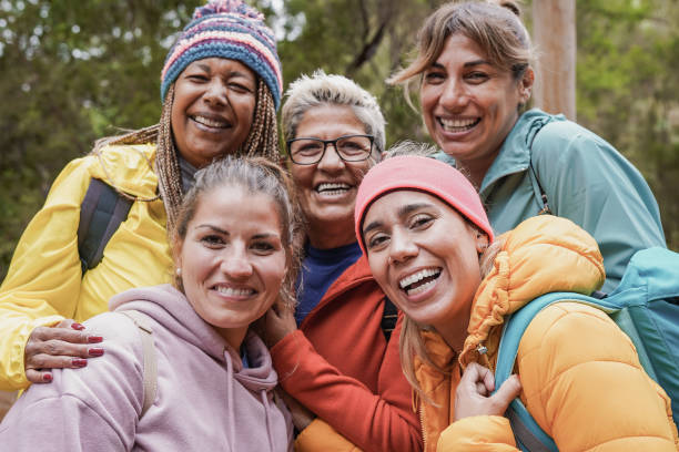 istock Multiracial women having fun taking a selfie during  trekking day - Multi generational people enjoy day in nature 1390663879