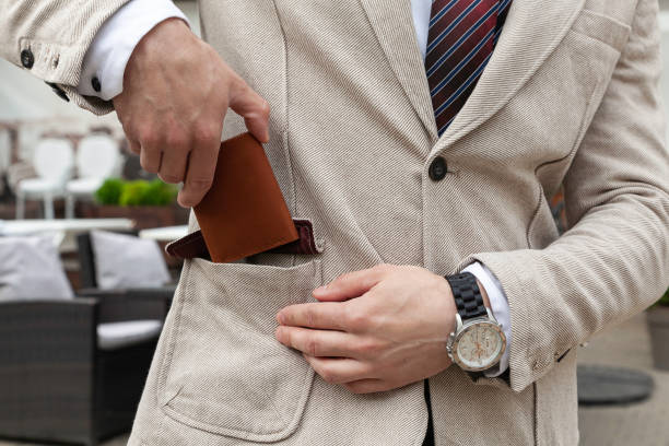 istock A business man puts a wallet in his jacket pocket 1390667507