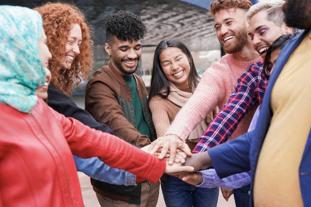 istock Group of young multiracial people stacking hands outdoor 1390670046