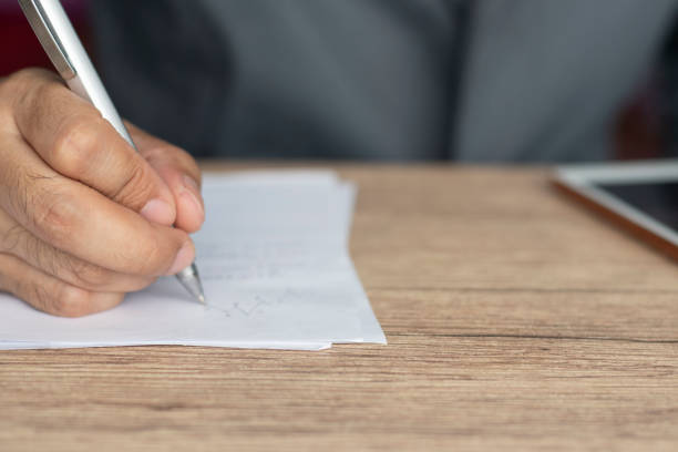 istock Businessman writing information on paper 1390671350