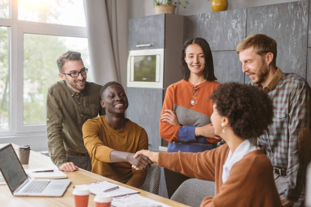 istock young business partners shaking hands. concept of cooperation 1390672817