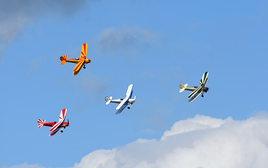 Ickwell, Bedfordshire, England - September 06, 2020: Vintage Tiger Moth Bi Planes Flying in formation blue sky and clouds.