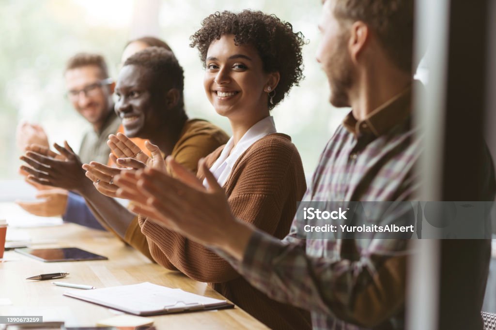 young woman and her colleagues applauding together young woman and her colleagues applauding together. close-up. Teamwork Stock Photo