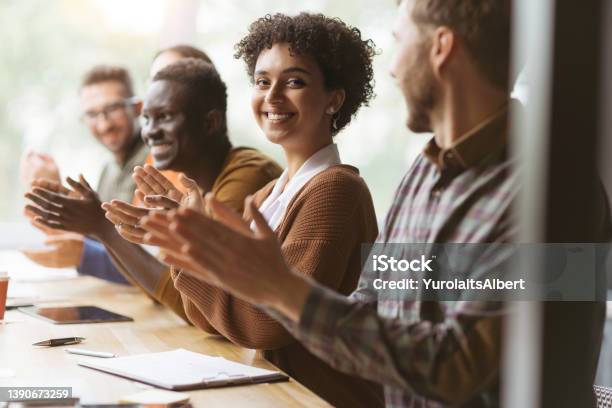 Young Woman And Her Colleagues Applauding Together Stock Photo - Download Image Now - Teamwork, Leadership, Applauding