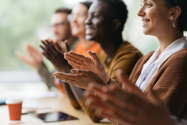 group of diverse business people applauding together stock photo