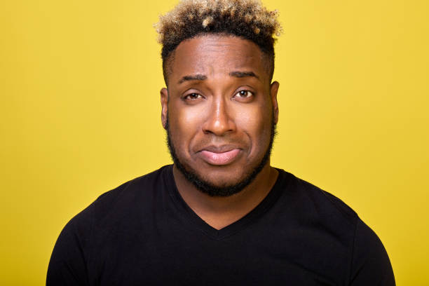 istock Upset guy in black T-shirt crooked his face looking into camera with sad eyes 1390673301